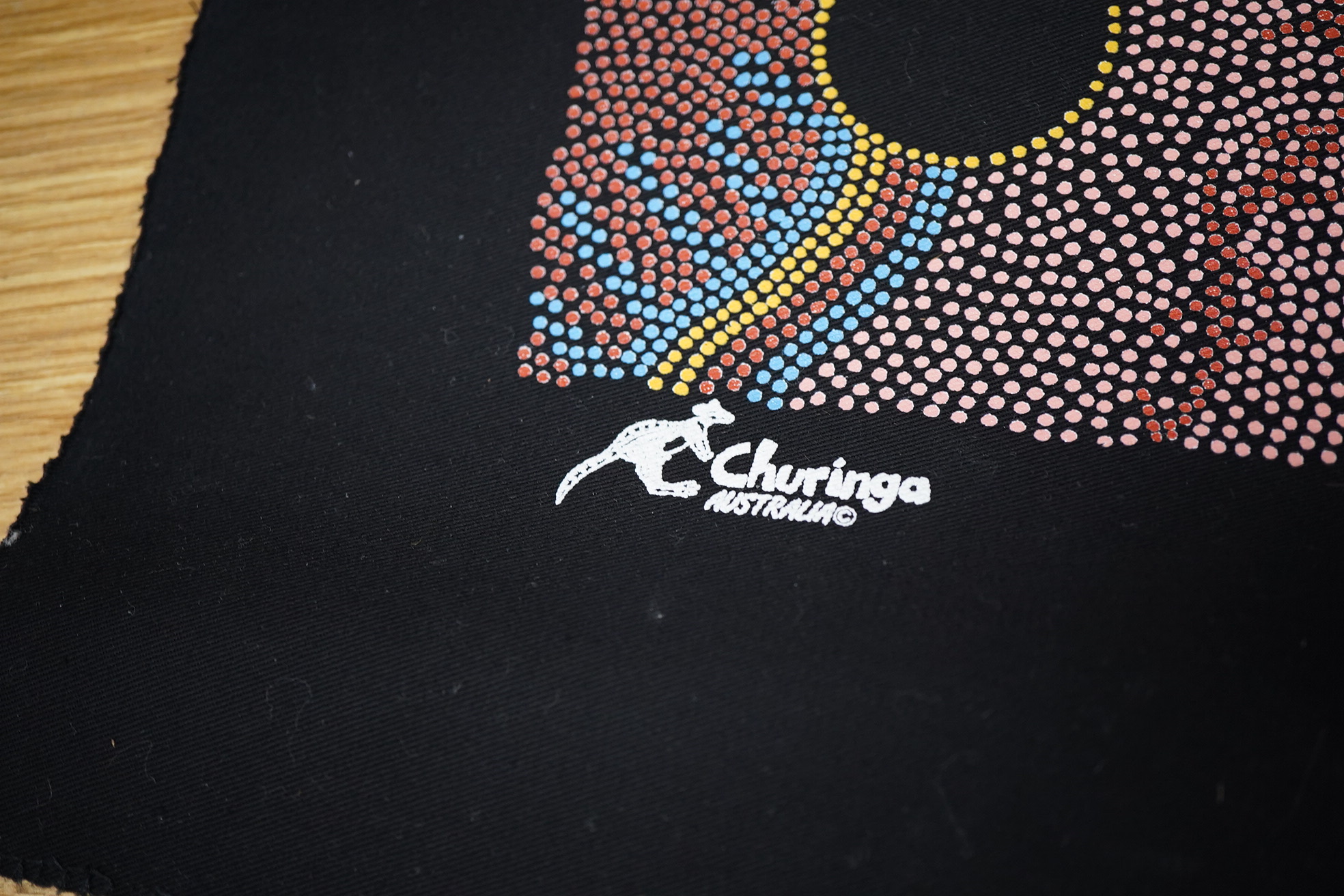 An Aboriginal painted wooden shield and a dot painted scroll
